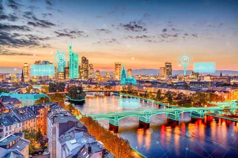 A cityscape at dusk with highlighted digital enhancements on buildings and bridges, designed using MicroStation, illustrating a smart city concept with vibrant, interconnected technology. | Bentley Systems | Infrastructure Engineering Software Company A cityscape at dusk with highlighted digital enhancements on buildings and bridges, designed using MicroStation, illustrating a smart city concept with vibrant, interconnected technology.