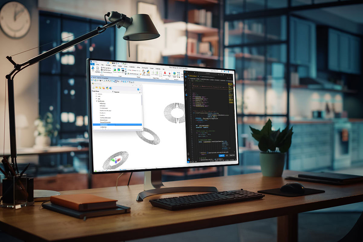 A computer screen displays a software interface with MicroStation 3D modeling on the left and code on the right. The desk includes a lamp, plant, keyboard, mouse, and notebooks, with a modern office backdrop.